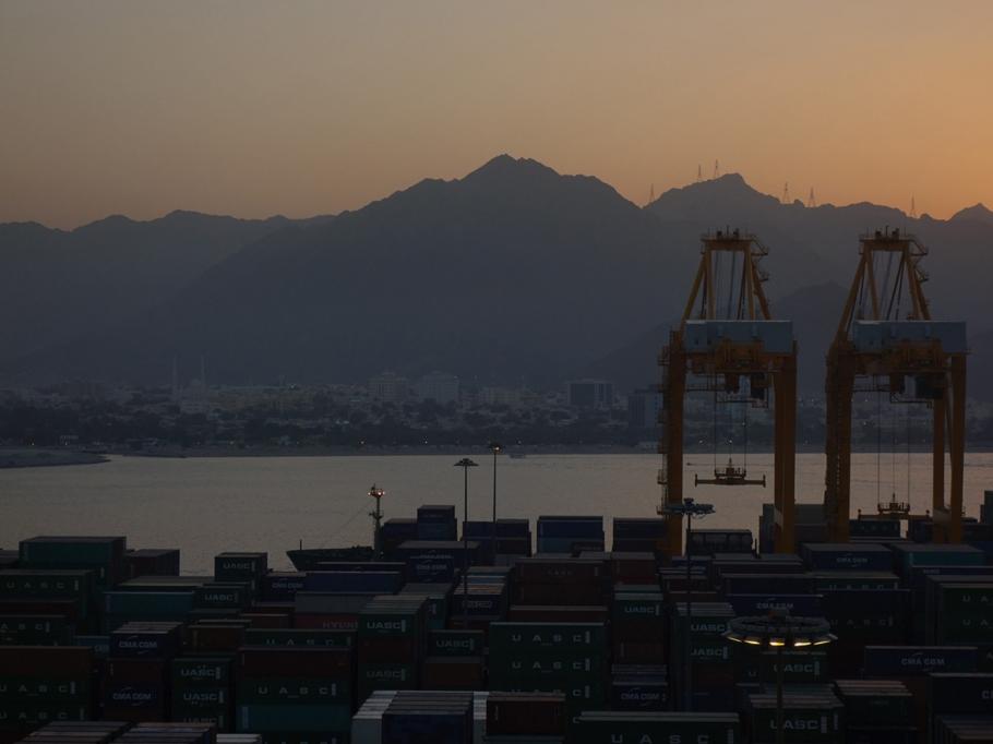 © GSD, Evening skyline of shipping port with mountain background