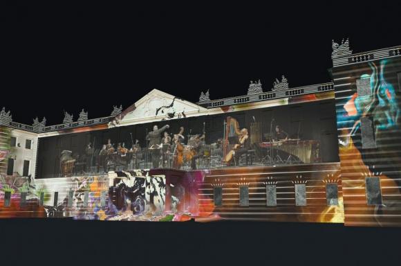 Zu sehen ist eine Visualisierung des beleuchteten Karlsruher Schlosses. Projiziert wurde ein Konzert umgeben von Graffitti-ähnlichen Abbildungen © IMWI und Computerstudio der Hochschule für Musik Karlsruhe, Nucleus, 2021, Bild: Patrick Borgeat